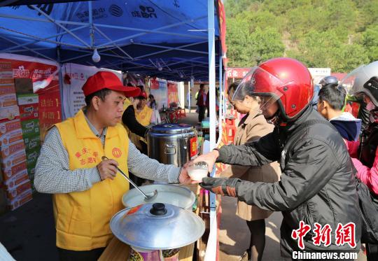 何县葵为返乡农民工送热粥 岑瑞青 摄
